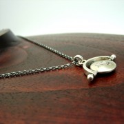 silver thaumatrope pendant