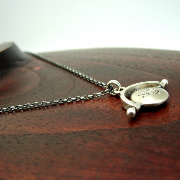 silver thaumatrope pendant