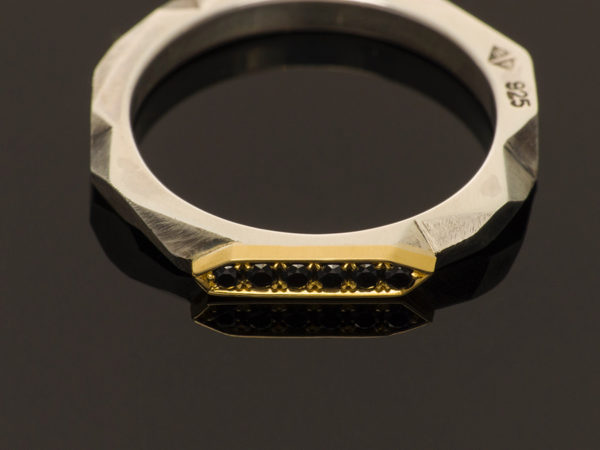 silver and gold faceted band with black diamond